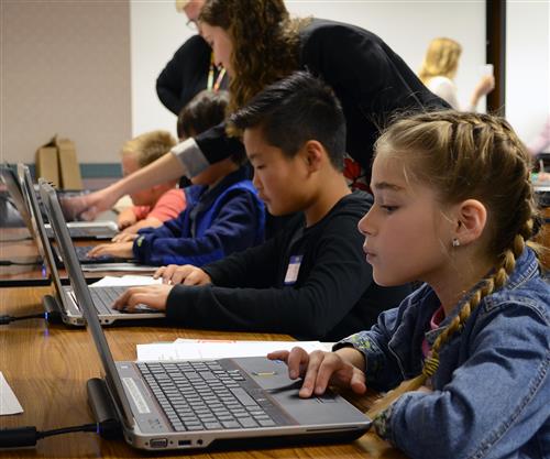 Students typing on computers 